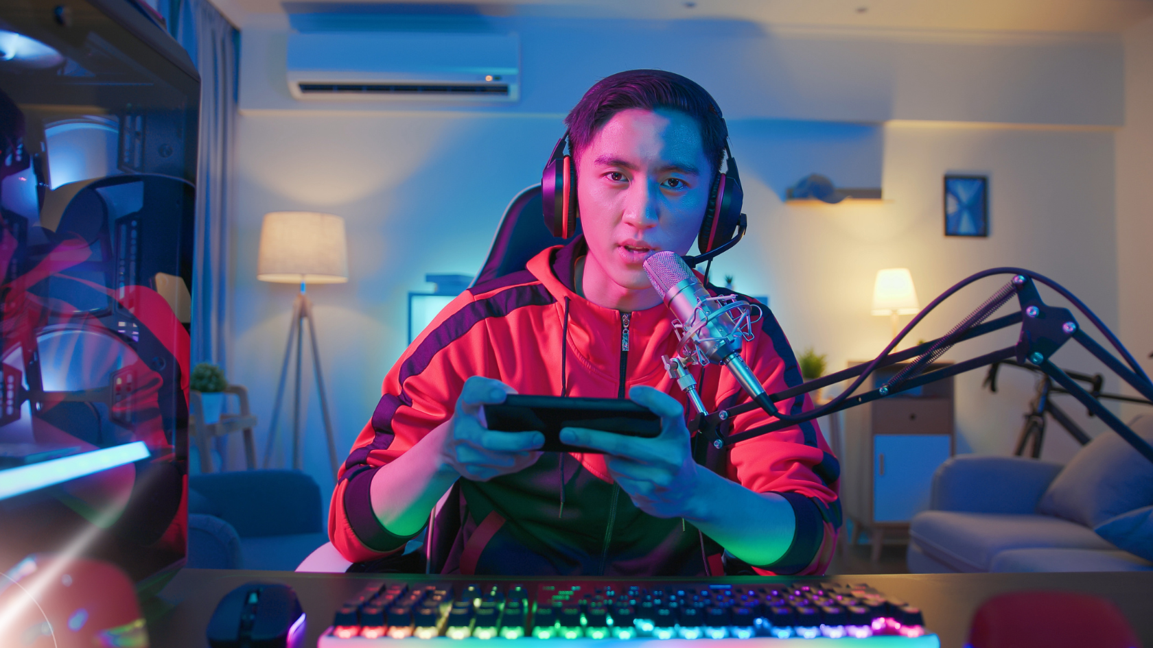 Streamer playing game with headset and microphone